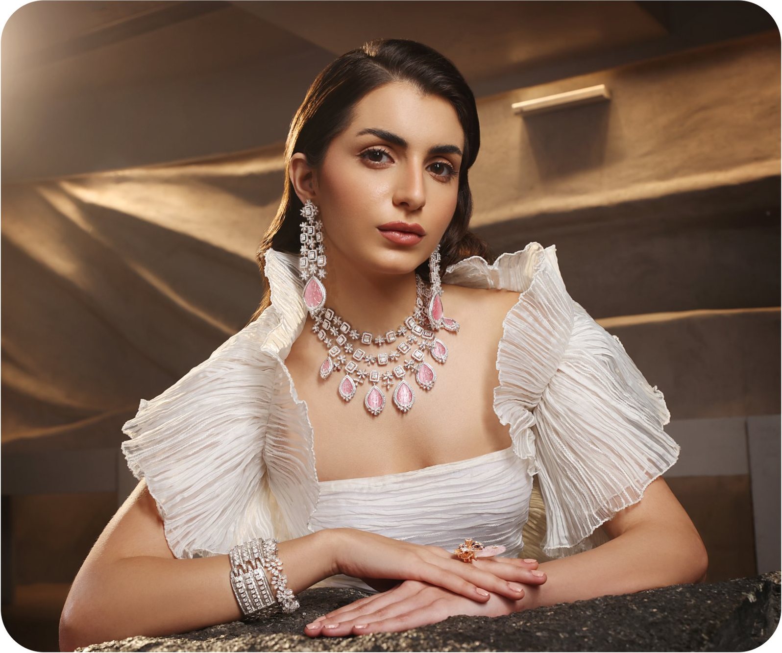 Model in white with a pink jewellery set